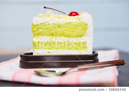 Green cake slice with cherry fruit and cream on Green cake slice with cherry fruit and cream on 58668340