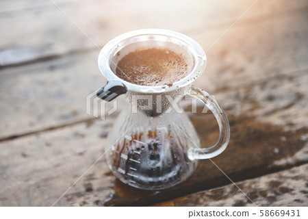 drip coffee barista pouring water on filtered 58669431