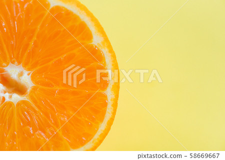 orange slice on yellow background / close up of 58669667