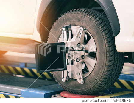 Wheel alignment equipment car mechanic installing 58669676