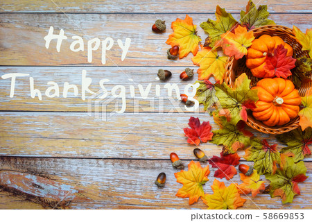 Autumn table setting with pumpkins on basket 58669853