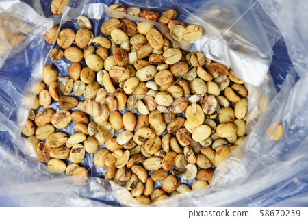 green unroasted coffee beans on plastic bag - raw green unroasted coffee beans on plastic bag - raw 58670239