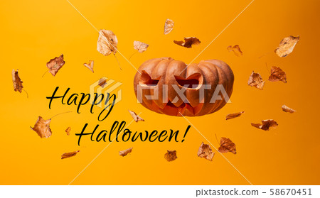 Scary pumpkin, flying dry leaves and inscription Happy Halloween Scary pumpkin, flying dry leaves and inscription Happy Halloween 58670451