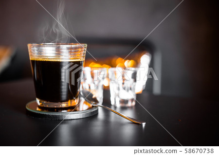 A cup of hot coffee with smoke. 58670738