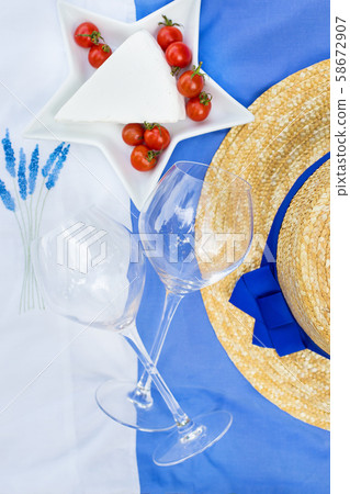 cheese, tomato, glasses on blue tablecloth with cheese, tomato, glasses on blue tablecloth with 58672907