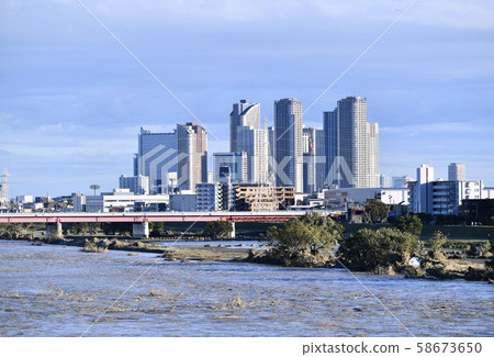 Tokyo cityscape in Japan Typhoon No.19 at dawn, water increase, muddy water Tama River. The afternoon filled with many visitors = 13th afternoon 58673650