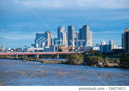 Tokyo cityscape in Japan One day after typhoon. Tamagawa River with increased water and muddy water. Musashi Kosugi at the back = afternoon of 13th 58673651