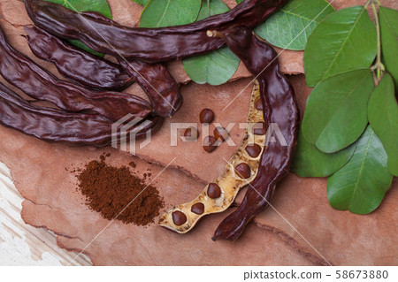 Carob. Organic carob pods with seeds and leaves Carob. Organic carob pods with seeds and leaves 58673880