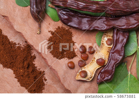 Carob. Organic carob pods with seeds and leaves Carob. Organic carob pods with seeds and leaves 58673881