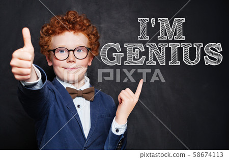 Happy little boy genius against chalkboard Happy little boy genius against chalkboard 58674113