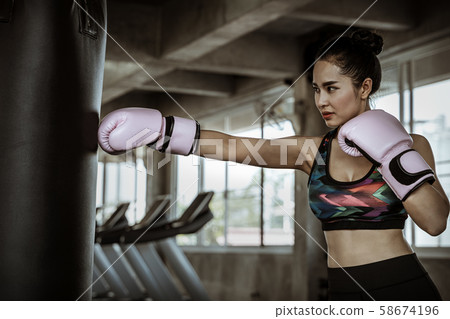 Beautiful Asian women are punching sandbags in the Beautiful Asian women are punching sandbags in the 58674196