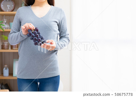 Woman with grape 58675778