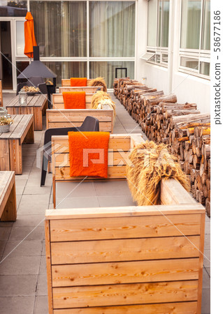 Outdoor restaurant terrace with wooden furniture Outdoor restaurant terrace with wooden furniture 58677186