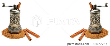 Cinnamon and manual grinder isolated on white Cinnamon and manual grinder isolated on white 58677234