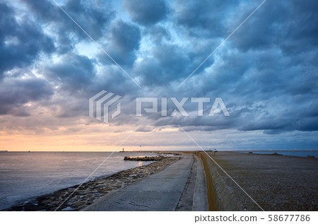 Concrete pier at scenic sunset with dramatic Concrete pier at scenic sunset with dramatic 58677786