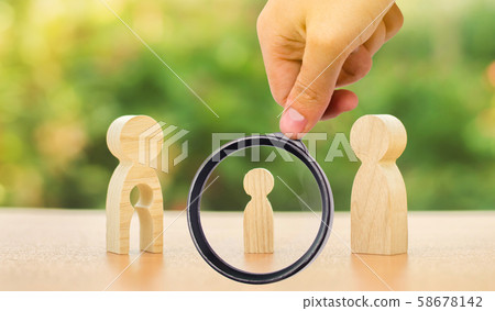 A magnifying glass looks at a child's figure stands between father and mother. The child chooses which parent to live with after their divorce. Guardianship over child. interest of child A magnifying glass looks at a child's figure stands between father and mother. The child chooses which parent to live with after their divorce. Guardianship over child. interest of child 58678142