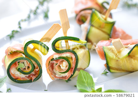 Zucchini appetizer rolls with delicious Italian ham and cream cheese with basil 58679021