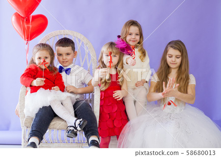 Kids boy and girls sit together at the party Kids boy and girls sit together at the party 58680013