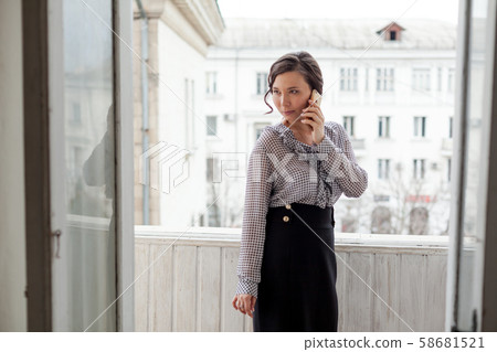 beautiful Asian woman talking on a smartphone beautiful Asian woman talking on a smartphone 58681521