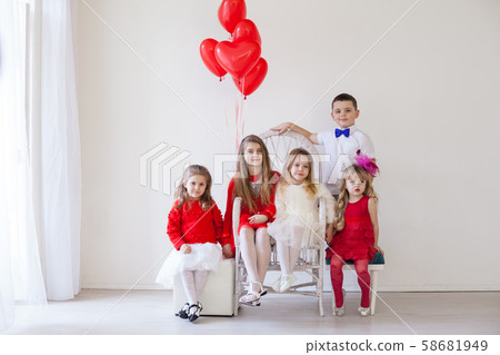four girls and boy in a white room with red balloons four girls and boy in a white room with red balloons 58681949
