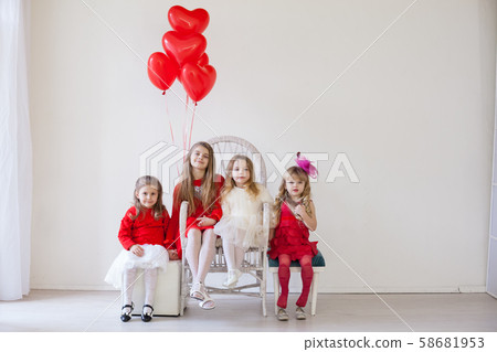 four girls in a white room with red holiday balloons four girls in a white room with red holiday balloons 58681953