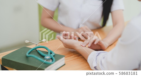 Cropped shot of female doctor checking her patient 58683181