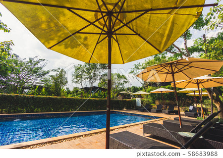 Relaxing area beside swimming pool Relaxing area beside swimming pool 58683988