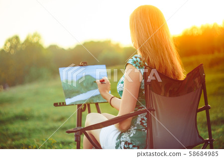 girl draws a picture in nature girl draws a picture in nature 58684985