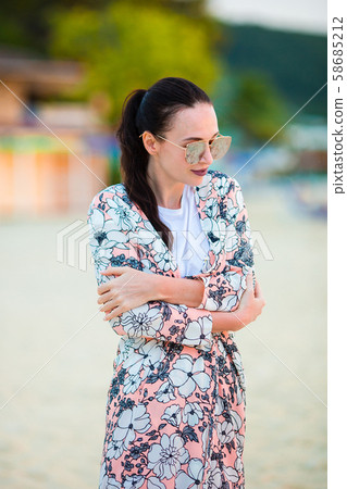 Young fashion woman in green dress on the beach 58685212