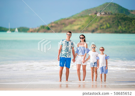 Happy family on the beach during summer vacation Happy family on the beach during summer vacation 58685652