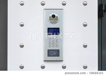 Close-up of white entryphone with identification system and videocamera Close-up of white entryphone with identification system and videocamera 58688101