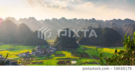 Panoramic view of Rapeseed flower field and villages at Wanfenglin National Geological Park (Forest of Ten Thousands Peaks), China Panoramic view of Rapeseed flower field and villages at Wanfenglin National Geological Park (Forest of Ten Thousands Peaks), China 58688176