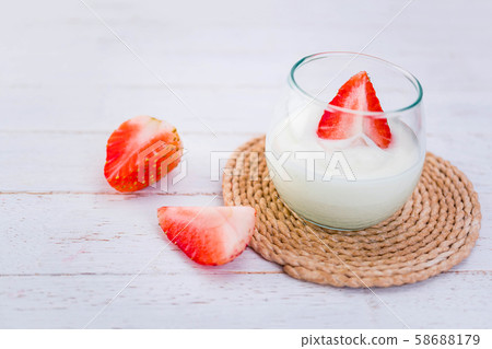 Original flavor yogurt with fresh strawberry in clear glass on white wood background 58688179