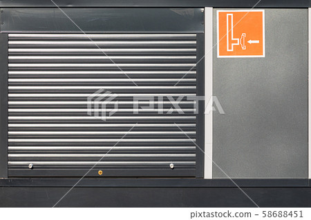 Metal roller shutter door with orange sign Metal roller shutter door with orange sign 58688451