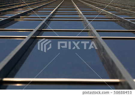 Ground view of mirrorlike office building wall 58688453