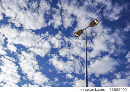 Three LED Street Lamps Affixed to an Iron Post Against a Deep Blue Sky Three LED Street Lamps Affixed to an Iron Post Against a Deep Blue Sky 58689403