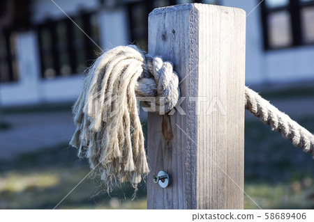 Row of wooden poles at the pier for security walkway. Row of wooden poles at the pier for security walkway. 58689406