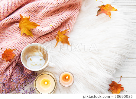 Cup of coffee and autumn leaves on a fur 58690085