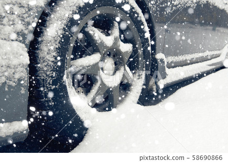 Cars tyre covered by snow on street in winter day Cars tyre covered by snow on street in winter day 58690866