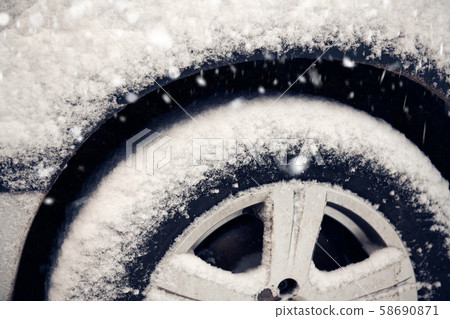 Cars tyre covered by snow on street in winter day Cars tyre covered by snow on street in winter day 58690871
