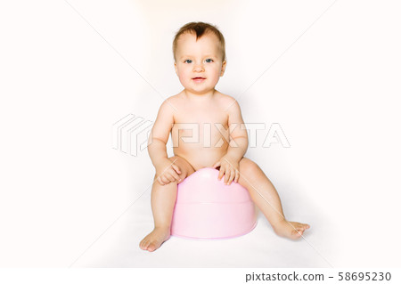 baby smiling and sitting on the potty baby smiling and sitting on the potty 58695230