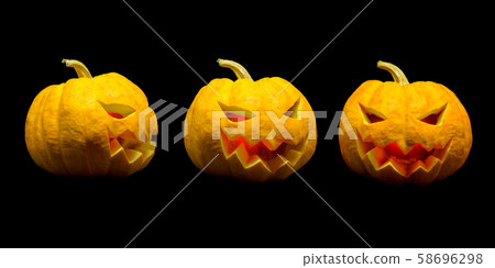 Jack o lantern pumpkin faces with lights on black background for Halloween season 58696298