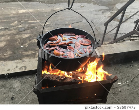 Mulled wine on fire with various fruits and spices 58697472