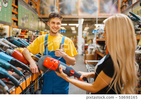 Assistant and female purchaser in hardware store Assistant and female purchaser in hardware store 58698165