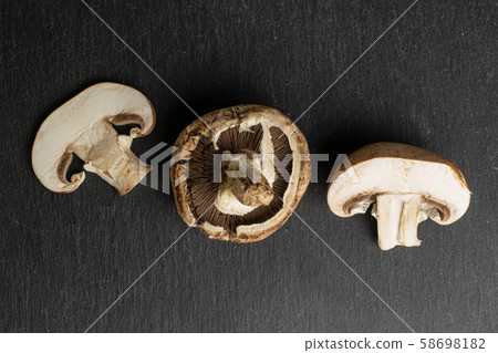 Fresh brown mushroom on grey stone Fresh brown mushroom on grey stone 58698182