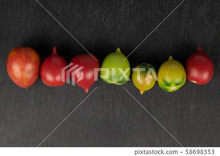 Fresh tomato de barao on grey stone Fresh tomato de barao on grey stone 58698353