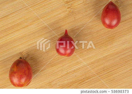 Fresh tomato de barao on light wood Fresh tomato de barao on light wood 58698373