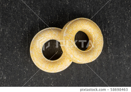 Pale round candy on grey stone Pale round candy on grey stone 58698463