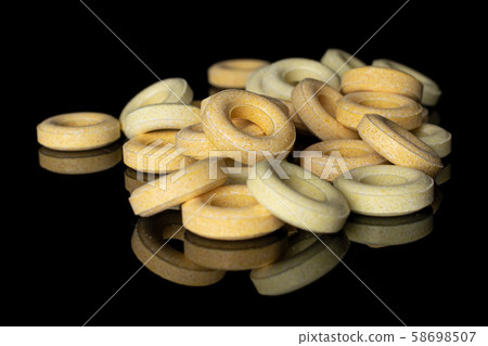 Pale round candy isolated on black glass Pale round candy isolated on black glass 58698507