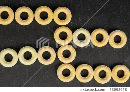 Pale round candy on grey stone Pale round candy on grey stone 58698658
